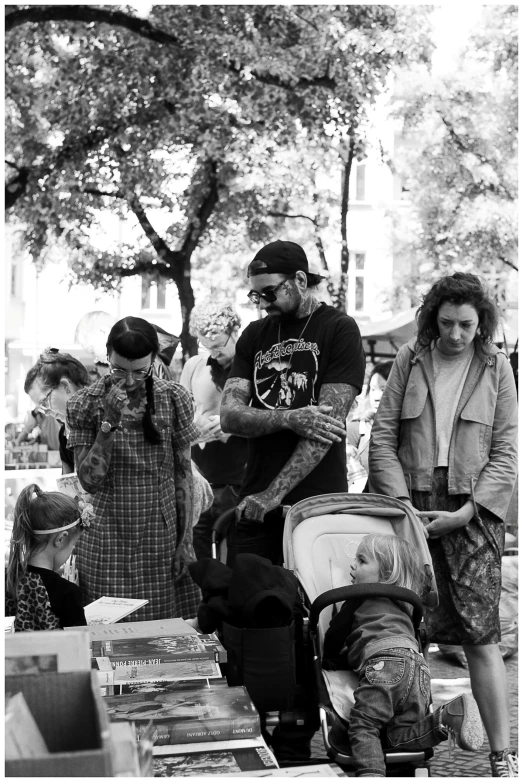 a person standing next to a stroller at an outdoor market