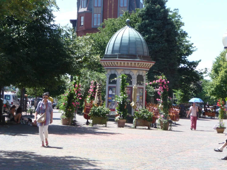 a park with a very pretty building and many flowers