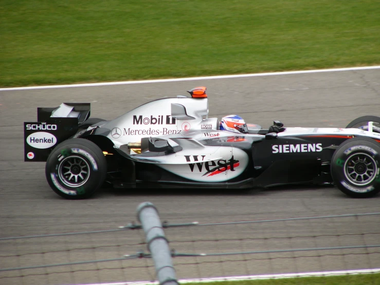 a driver is driving his car on the track