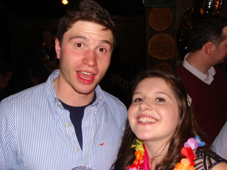 two people wearing leis posing for the camera