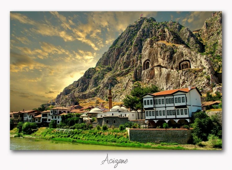 a large mountain sits near a small town