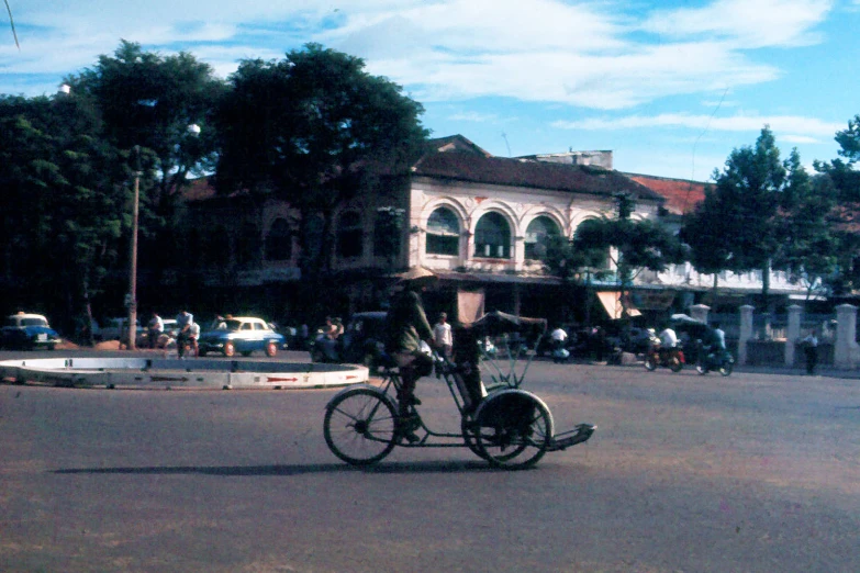 man on a bicycle driving down the street