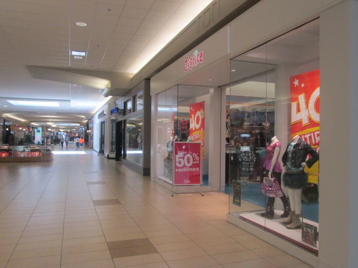 a shopping mall with some people walking through