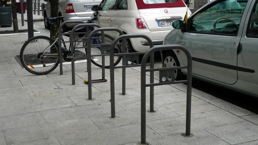 a bike is locked to a parking meter on the sidewalk