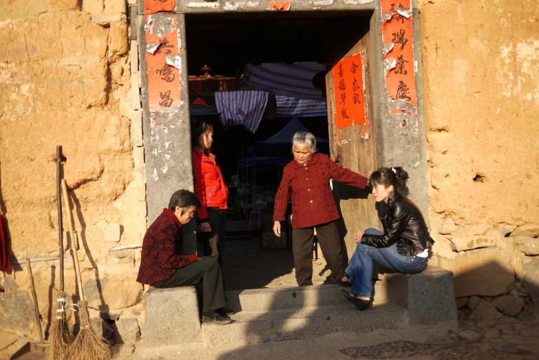 a couple of people sitting on steps in front of a building