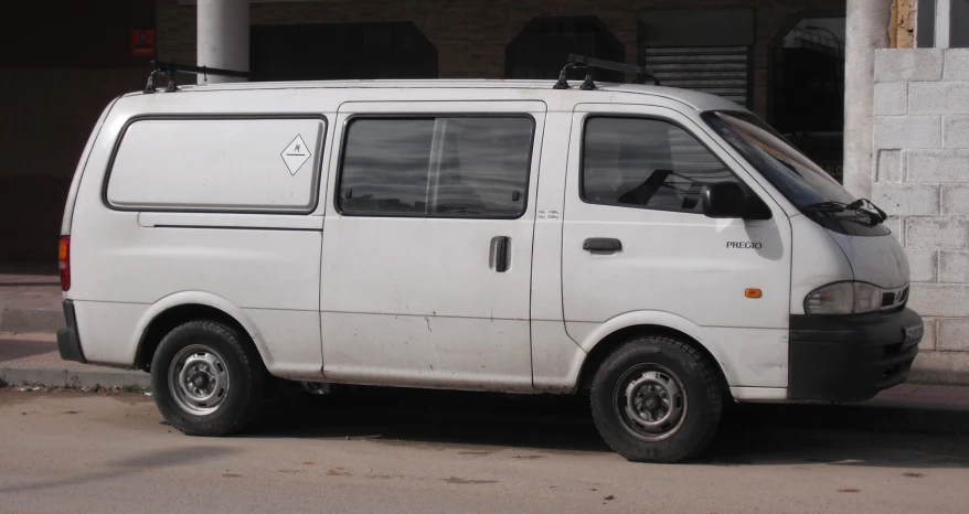 a white van parked in front of a building