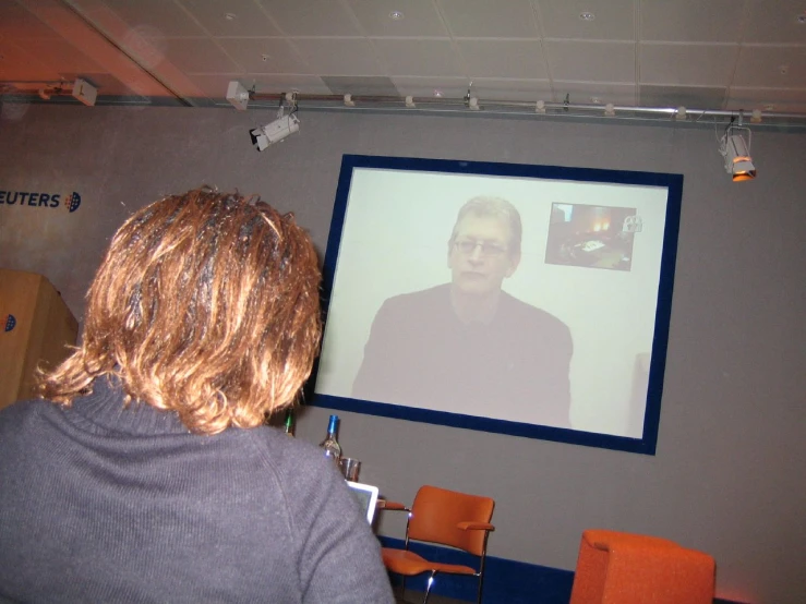 a woman watching an animated movie on the wall