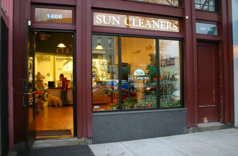 a store front with people walking by the store