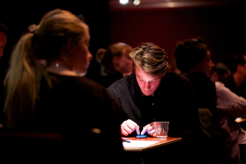 many people are sitting at the table together