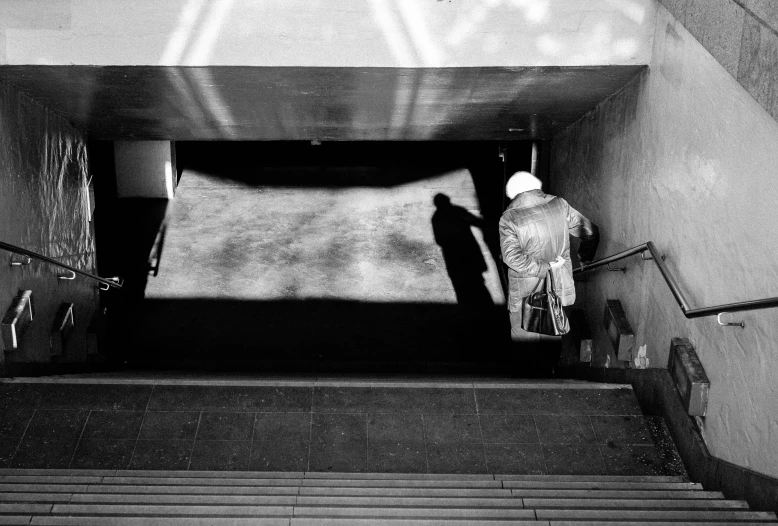 a person with a snowboard walks up some steps