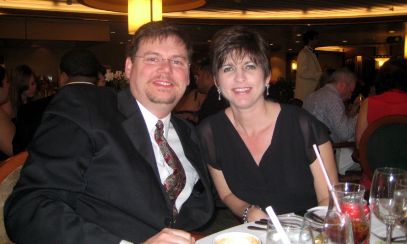 a woman sitting next to a man in a suit