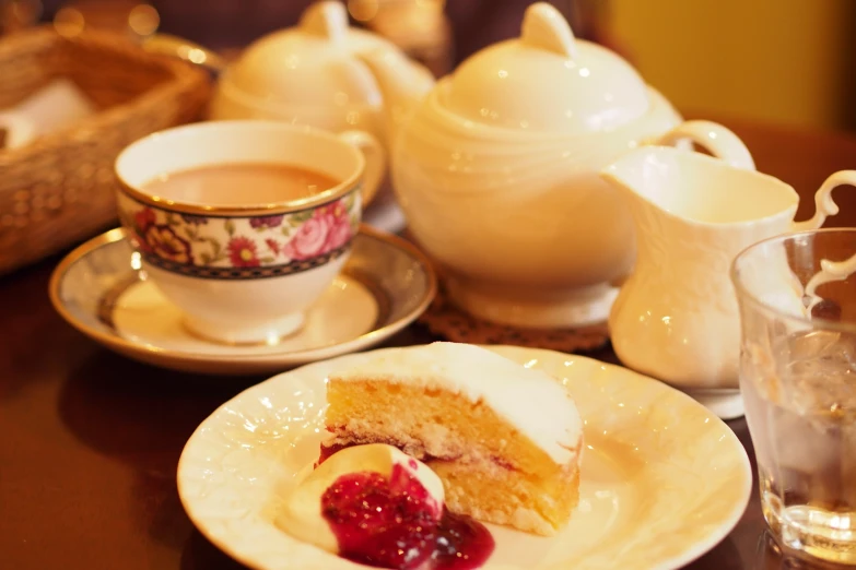 a dessert sitting on top of a white plate next to a cup of coffee