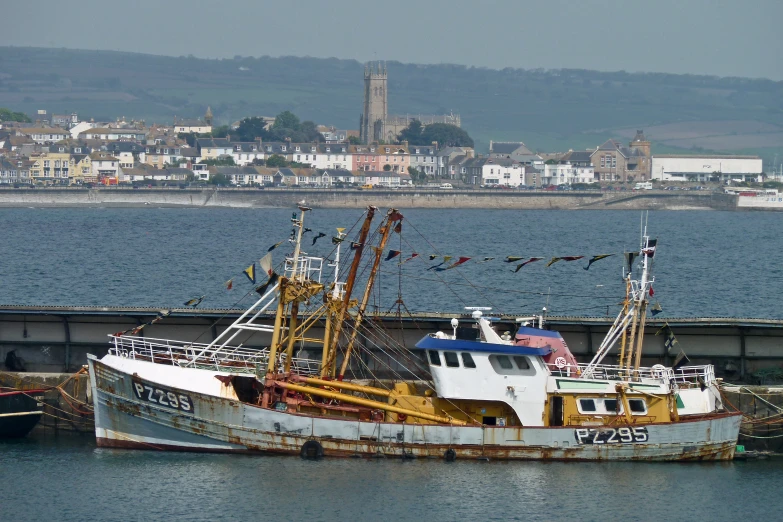 the fishing boat is pulled up at the dock