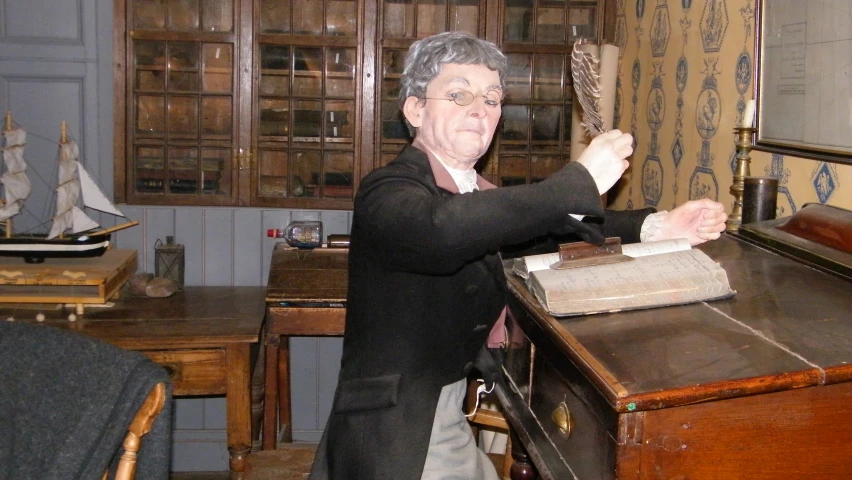 a man is cleaning a piece of paper with some scissors