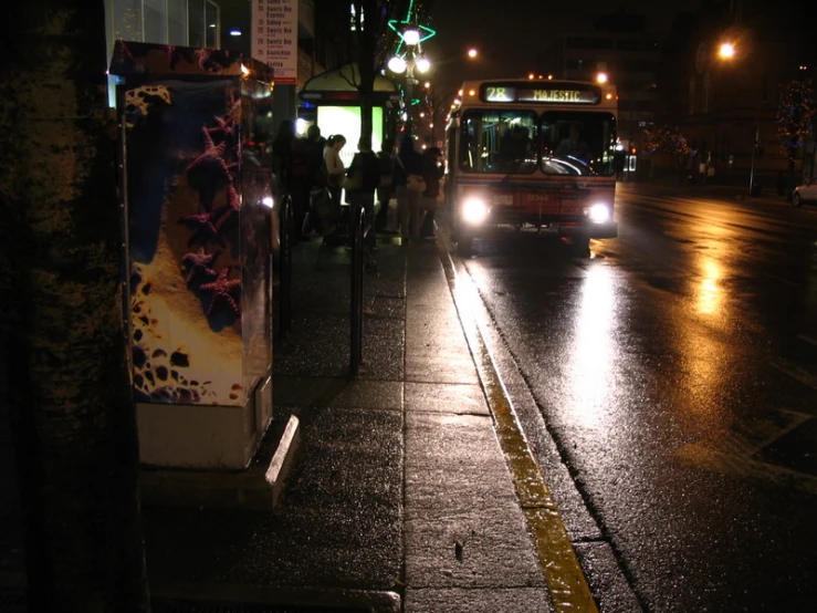 a bus traveling on a road in the rain