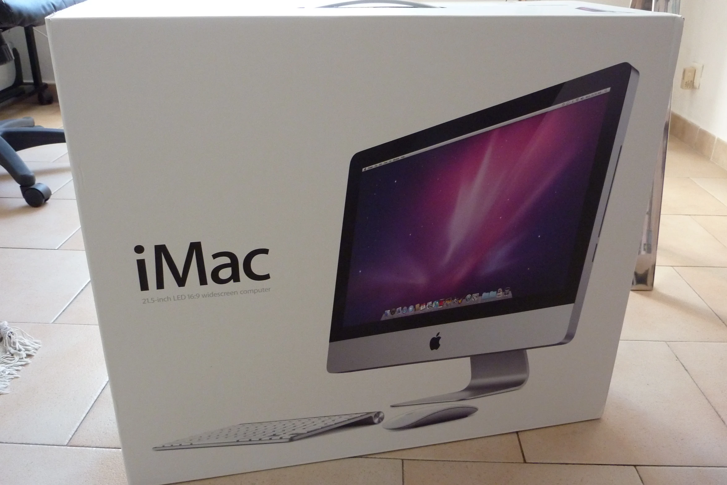 a mac computer sitting in a box on the ground