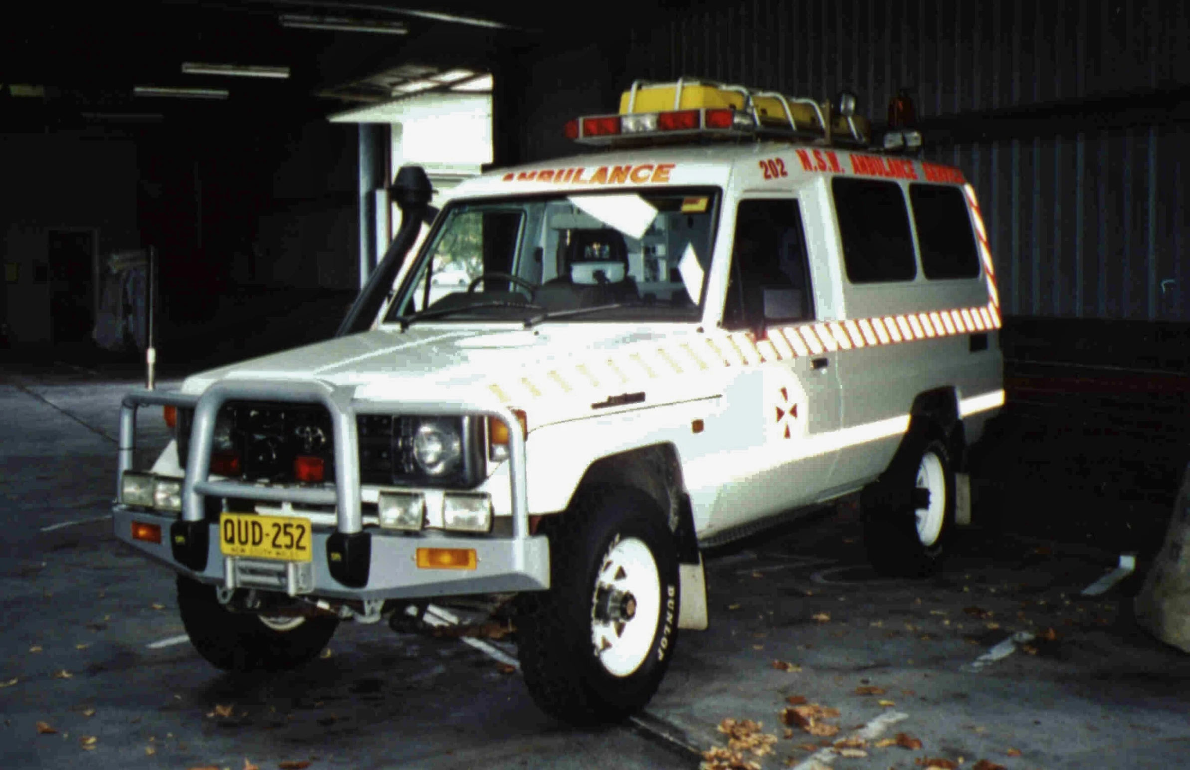 an ambulance with an emergency light sitting in a garage