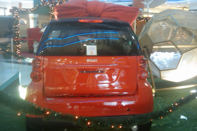 a red suv parked inside of a building