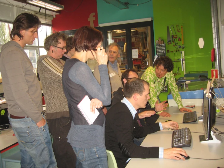 a group of people gathered around a white table