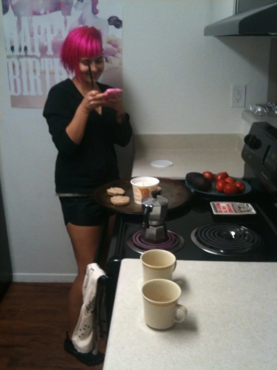 a girl standing in front of a counter taking a picture