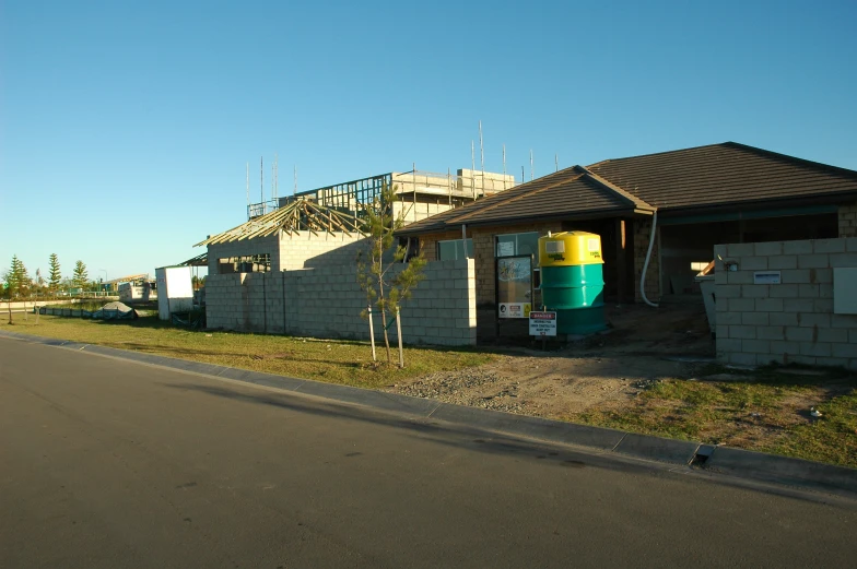 houses under construction with water well in front