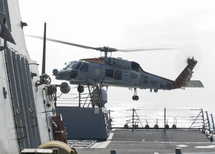 a large helicopter is taking off from the carrier
