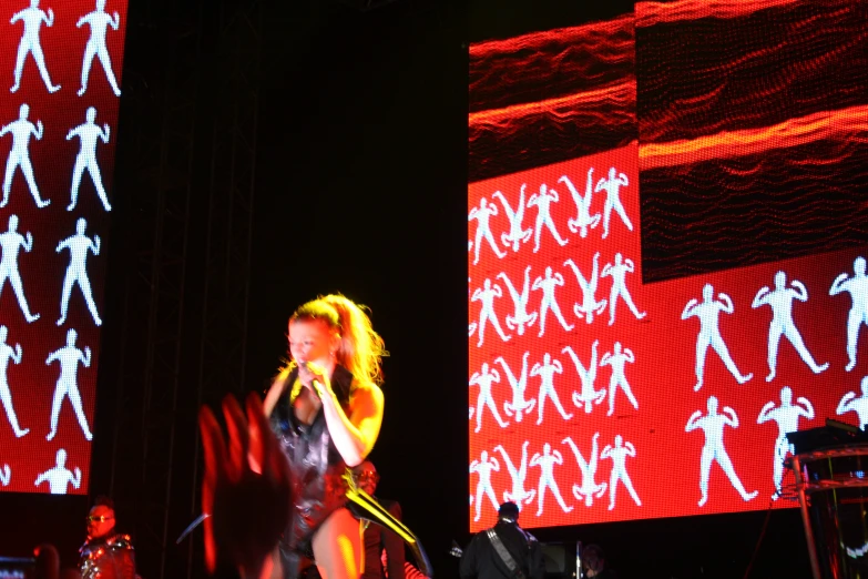 a woman on a stage singing into microphone