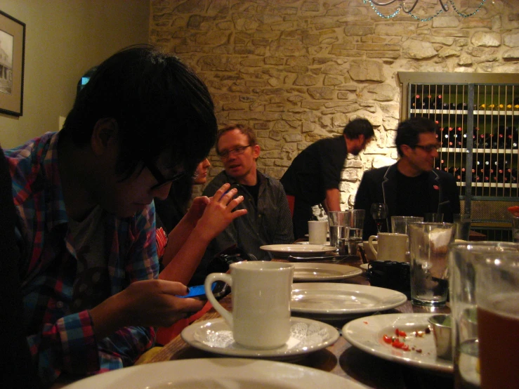 a man is taking a drink at a table