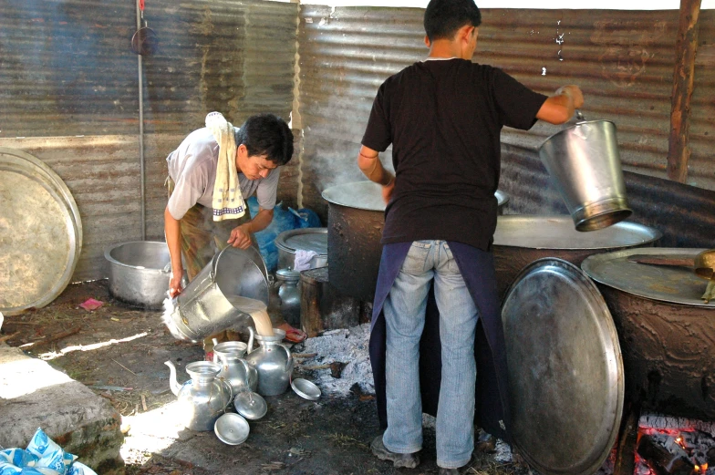 two people with pots in an outside area