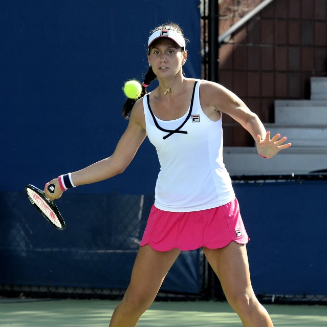 a female tennis player about to serve the ball