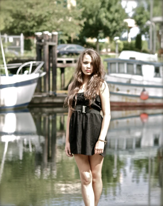 a pretty young woman posing on the water