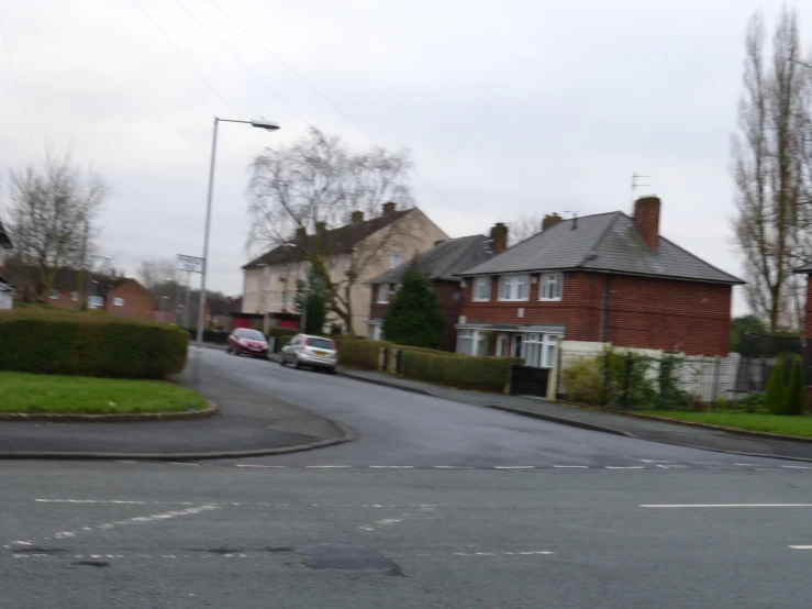 a street view of a neighborhood on a cloudy day