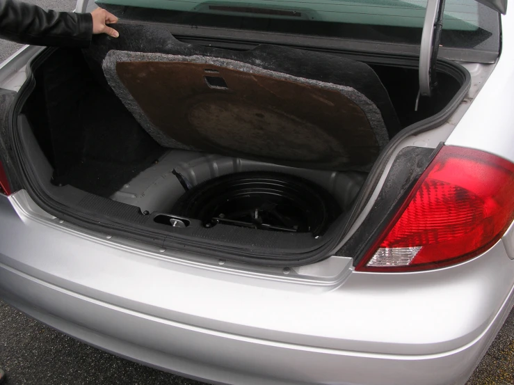 a car has the hatch up open to show its sub