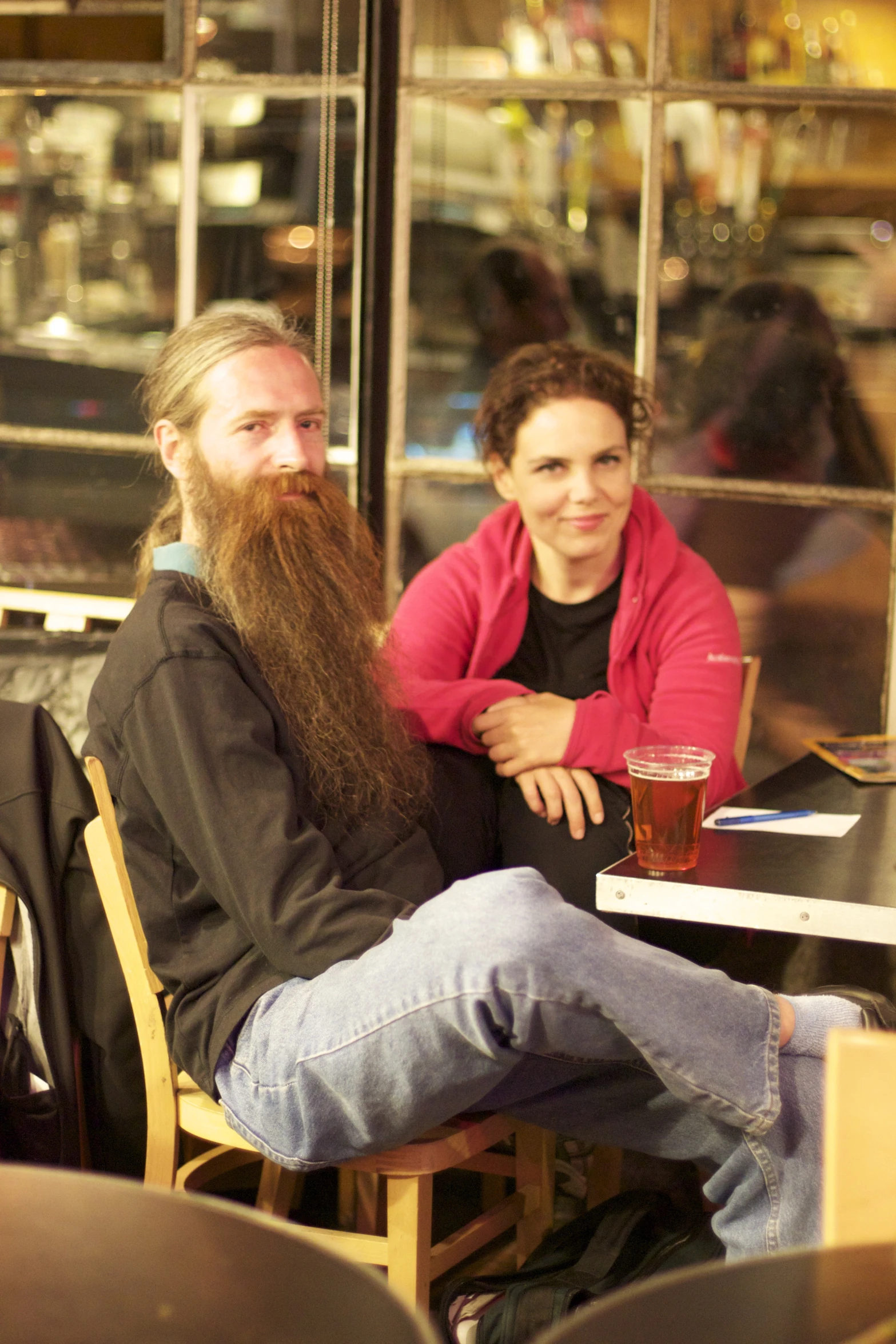 a woman sitting next to a man at a table