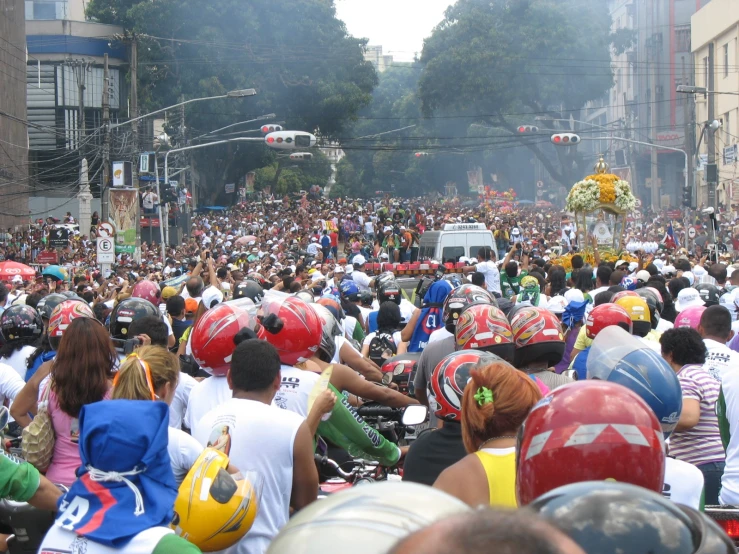 large group of people riding bicycles wearing colorful helmets