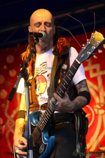 a man with long hair and beard playing guitar