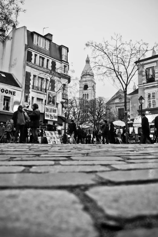 people walking around near large buildings in an old town