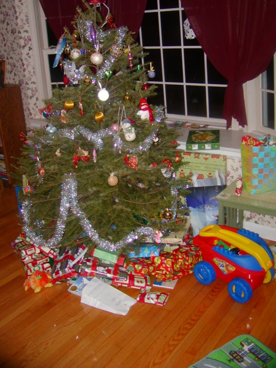 a christmas tree that is decorated with presents