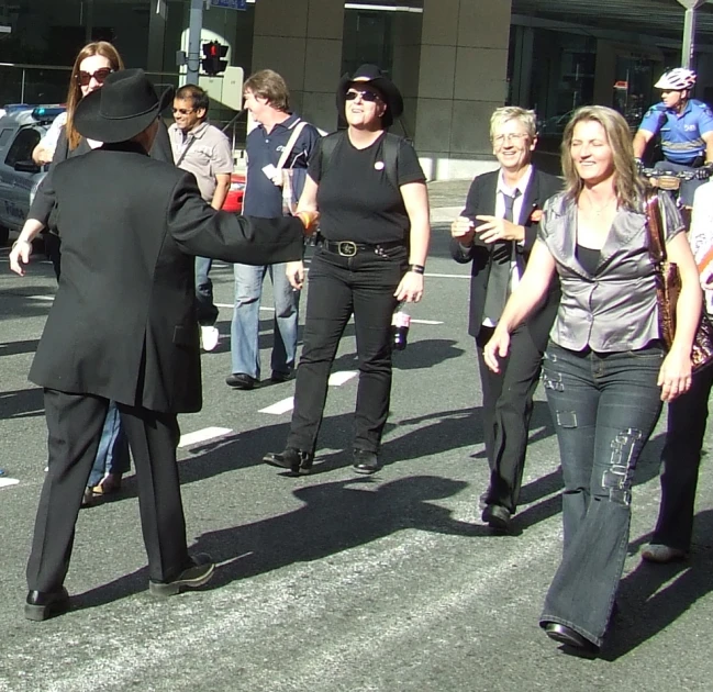 a group of people walk across the road