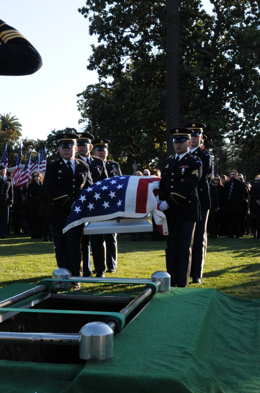 some guys wearing uniforms and people holding flags