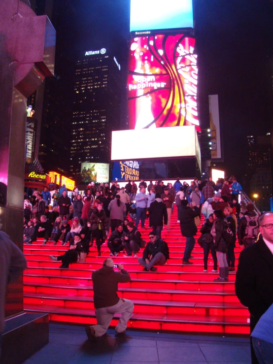 the people are walking up the stairs outside in the night