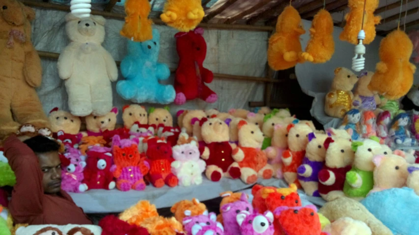 a lot of colorful stuffed animals on display