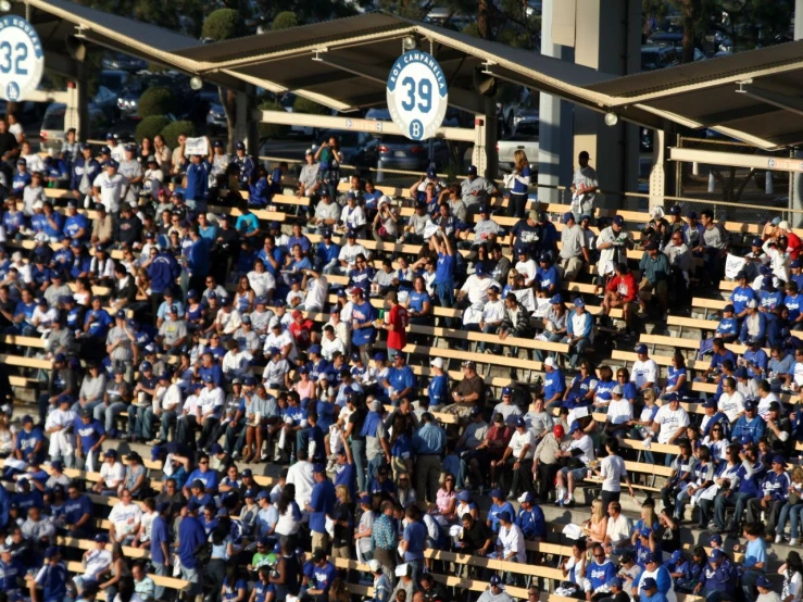 the fans are sitting and watching the baseball game