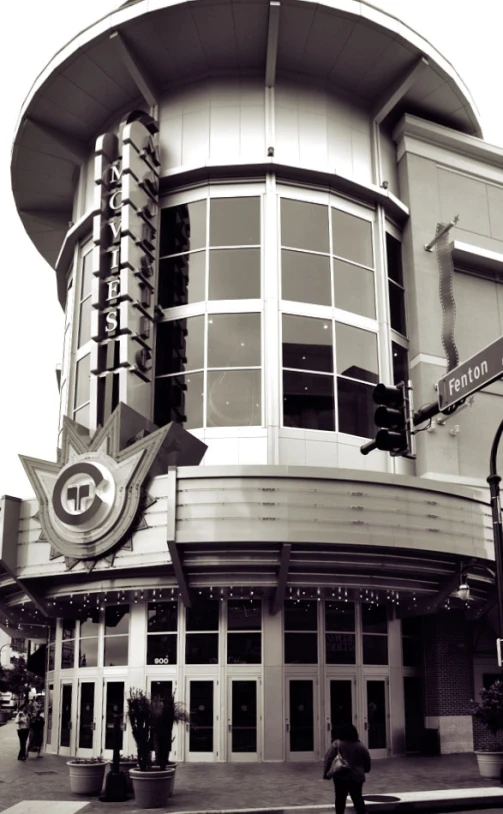 there is a person walking past a large building