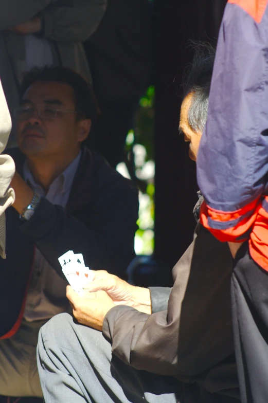 two people are playing cards in the park