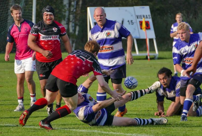 men playing soccer against each other on a field