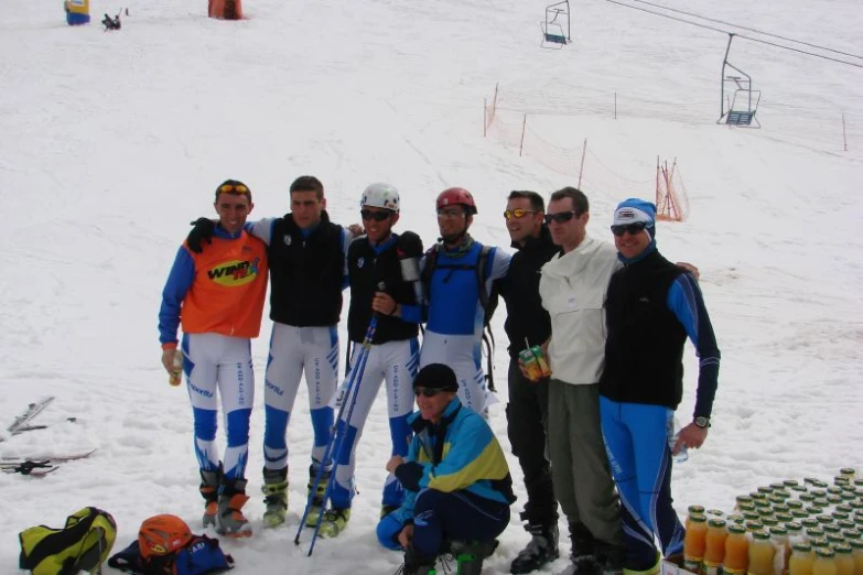 several men who are standing together on some skis