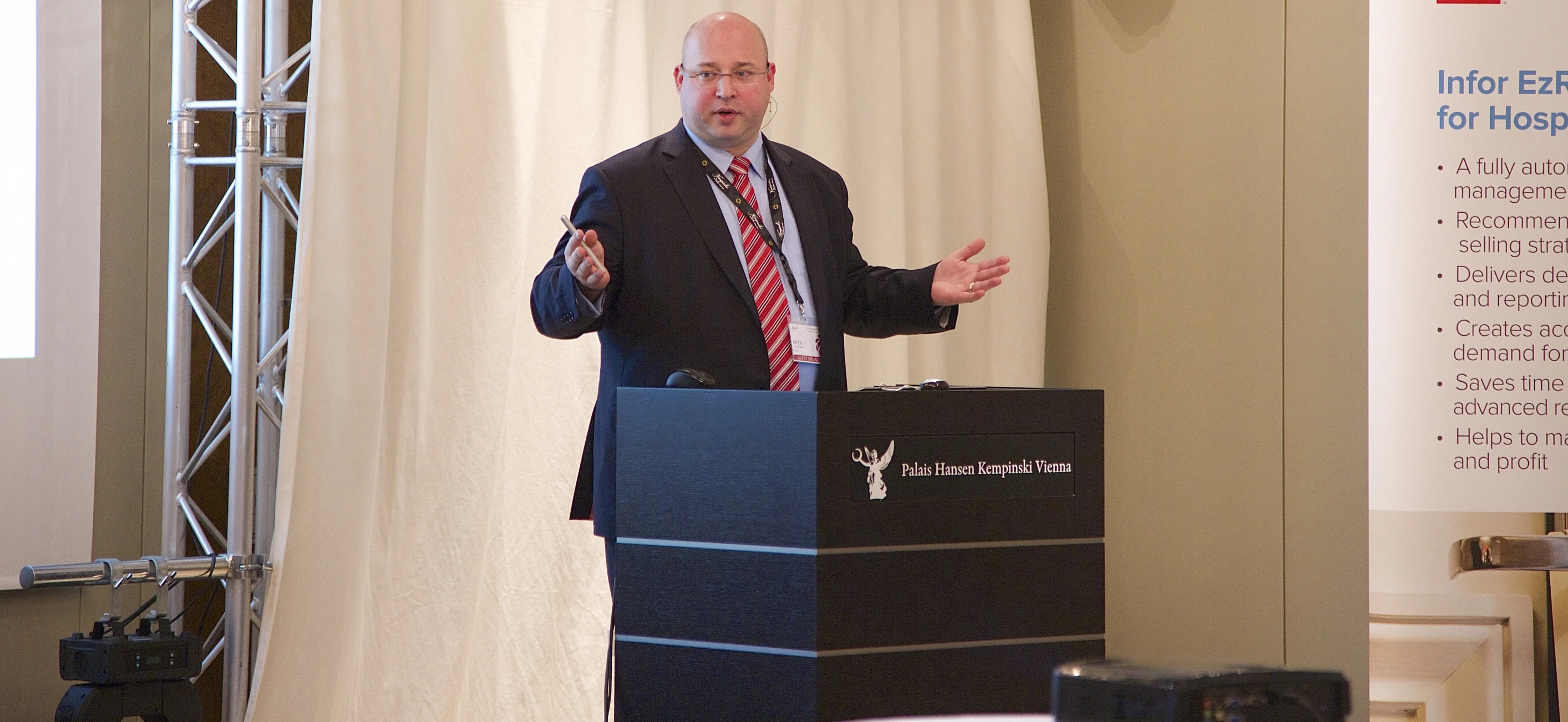 a man standing in front of a podium giving a presentation