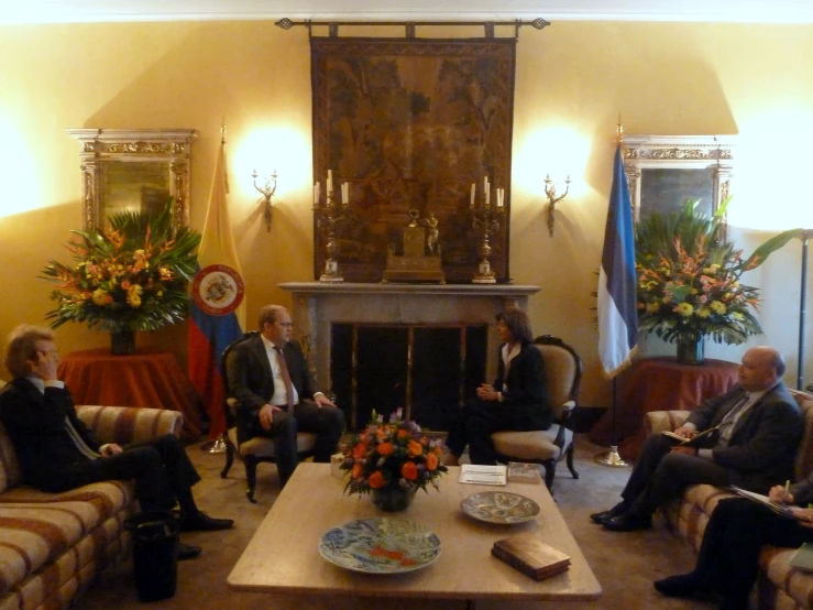 four men sitting around in a living room together