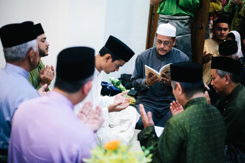 group of people wearing traditional clothing sitting down